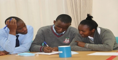 Learners engaged in a mathematics activity during a school visit at CEMASTEA