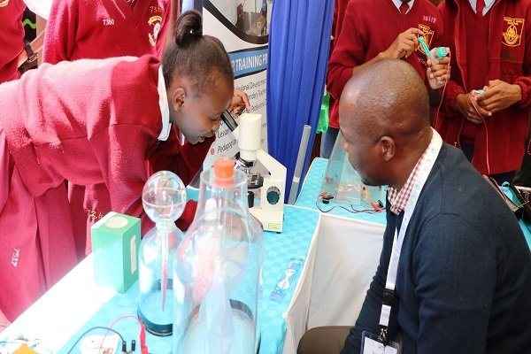A learner interacts with a microscope during the 2nd Multi-Sectoral Conference on Science, Technology and innovations (MS-COSTI 2) displayed at the CEMASTEA booth