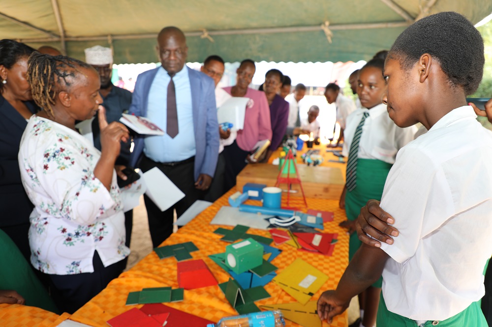 The Coordinator of Special Programmes and Student learning at CEMASTEA Mrs. Beatrice Macharia motivates students at Mulango Girls High school to pursue careers in STEM during the International Day for Women and Girls in Science. 