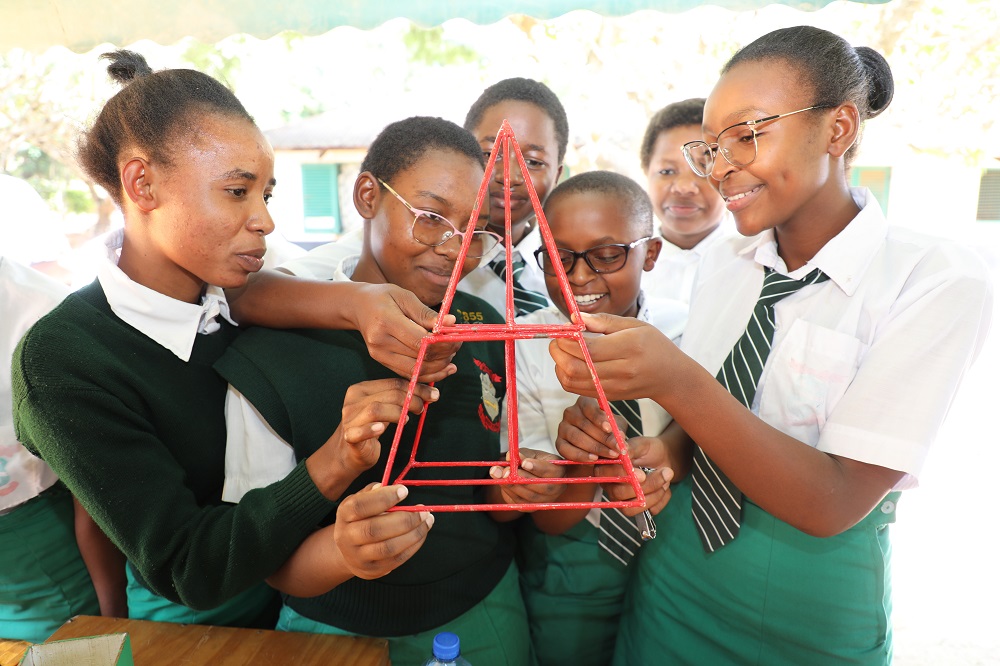 Mulango Girls High School students study  a teaching and learning aid for Mathematics at a Mathematics booth at the school set up by CEMASTEA to mark this year`s International Day for Women and Girls in Science.