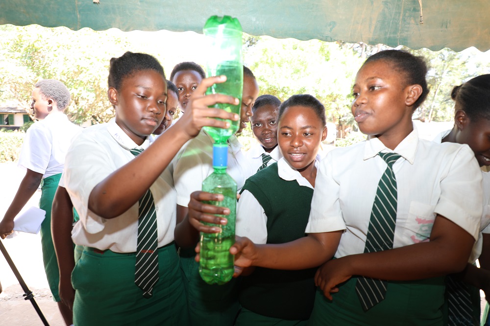 Mulango Girls High school students in Kitui County experiment a concept in physics  during a STEM mentorship program organized by CEMASTEA